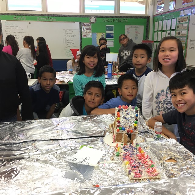 Students embrace the holiday spirit by working together to create gingerbread houses!
